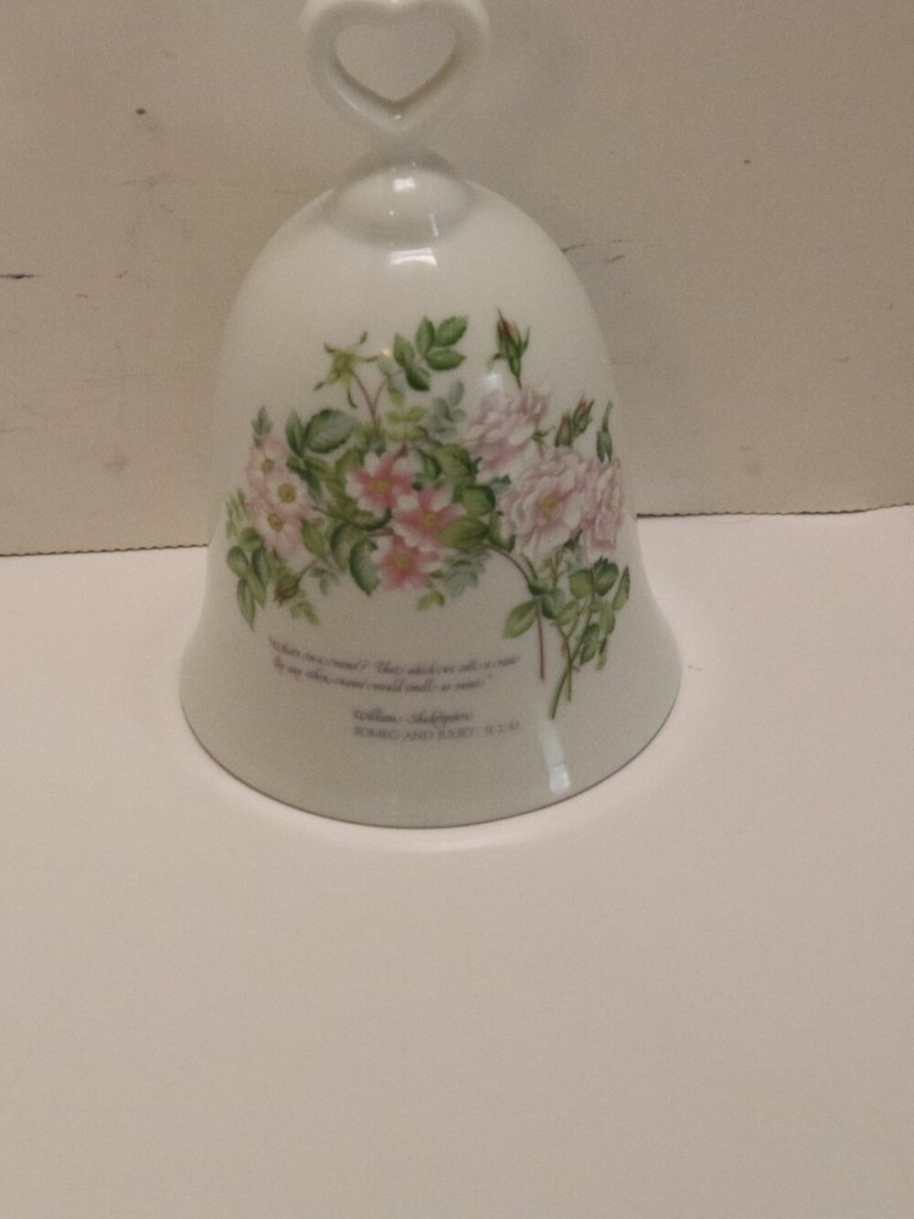 A Porcelain Bell with a Picture of a Rose and an inscription from W Shakespeare